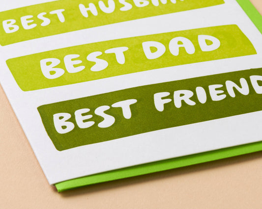 Card with text 'Best Husband', 'Best Dad', 'Best Friend' on green and white stripes.