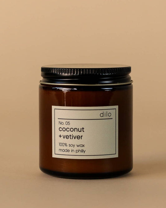 coconut and vetiver scented soy wax candle in a glass jar