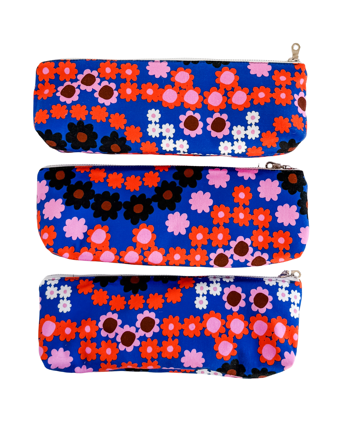three floral-patterned pouches on a white background