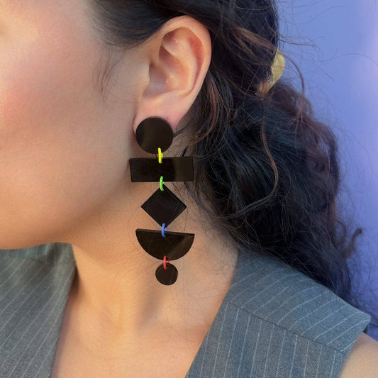 Close-up of a person wearing a unique earring with geometric design.
