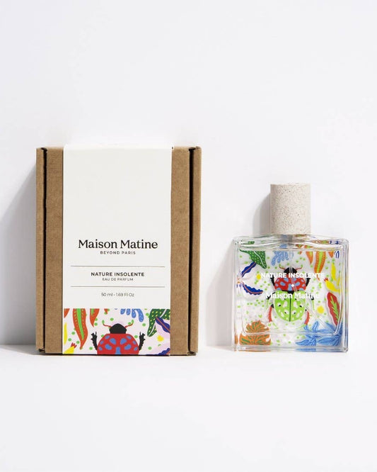 Maison Matine parfum "Nature Insolente" glass bottle standing next to an equally colorful box for packaging.