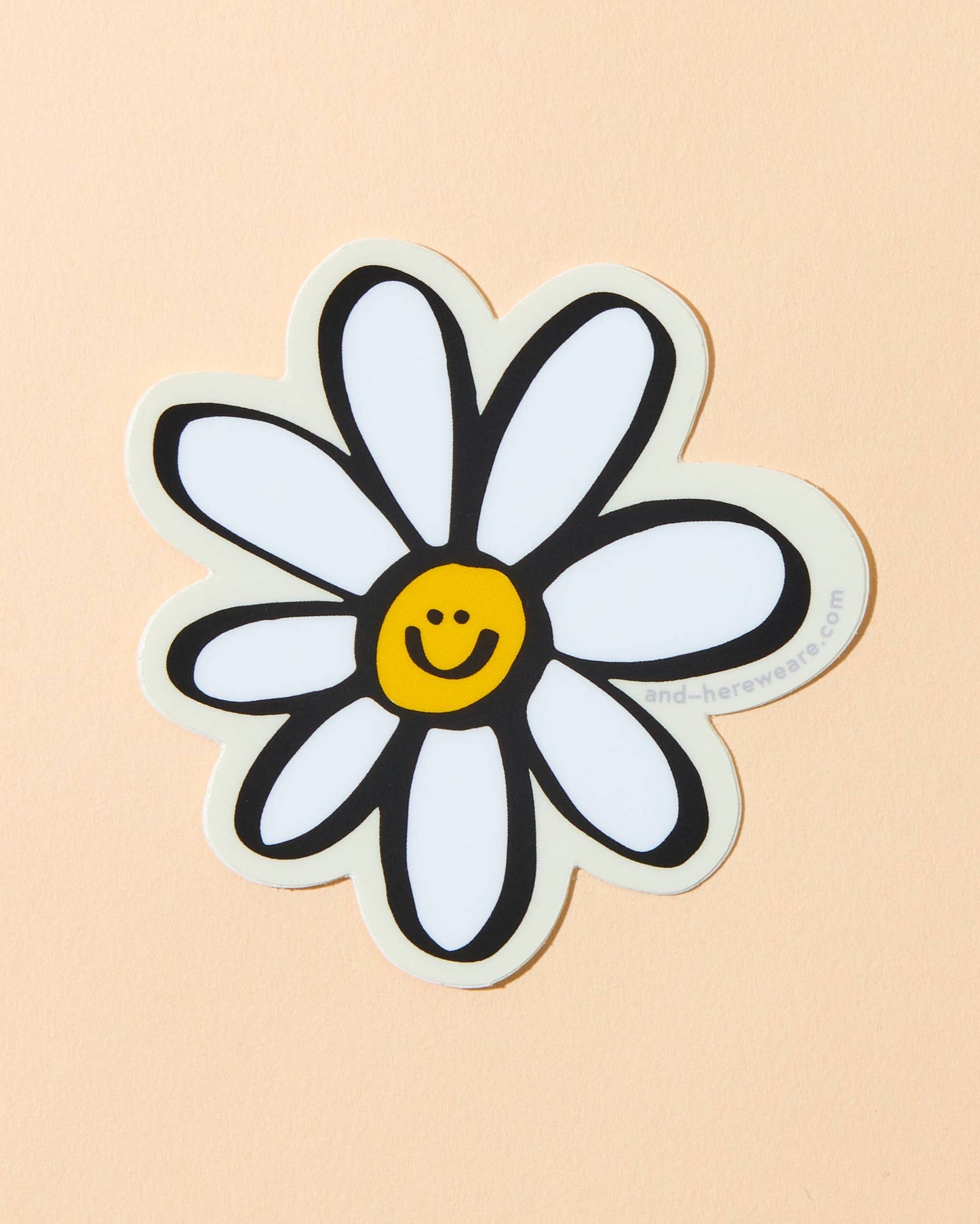 illustrated vinyl sticker of a daisy with a smiley face in the middle