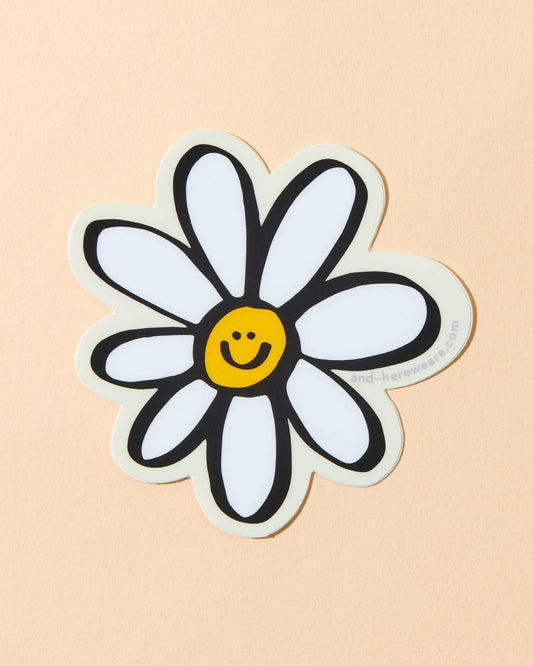 illustrated vinyl sticker of a daisy with a smiley face in the middle