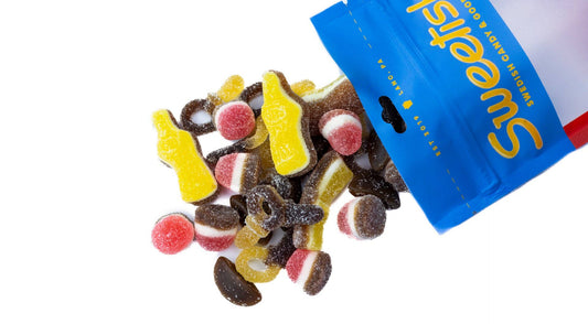 Assorted Swedish gummy candies with a blue 'Sweetish' bag on a white background