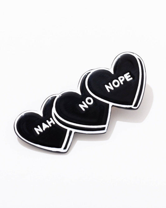 hairclip with black hearts that say nah, no, nope
