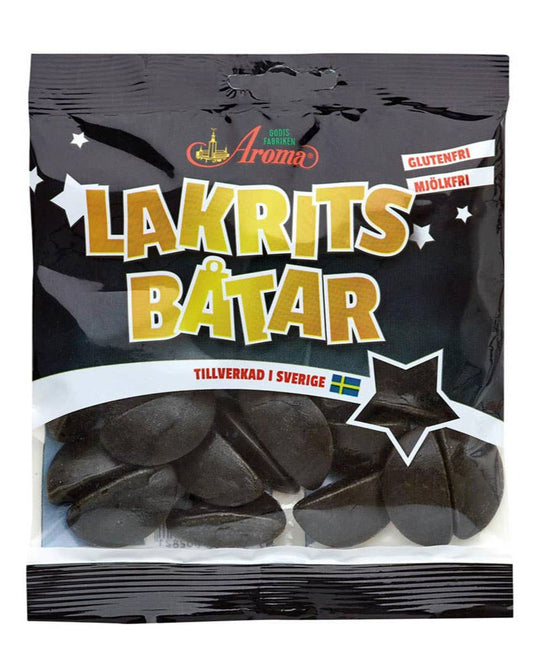 A package of Aroma brand Lakritsbåtar, which are licorice boats. The package is predominantly black with gold and white text, and features an image of the licorice product.
