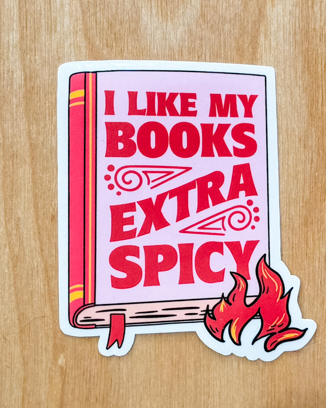 pink sticker that says: I like my books extra spicy