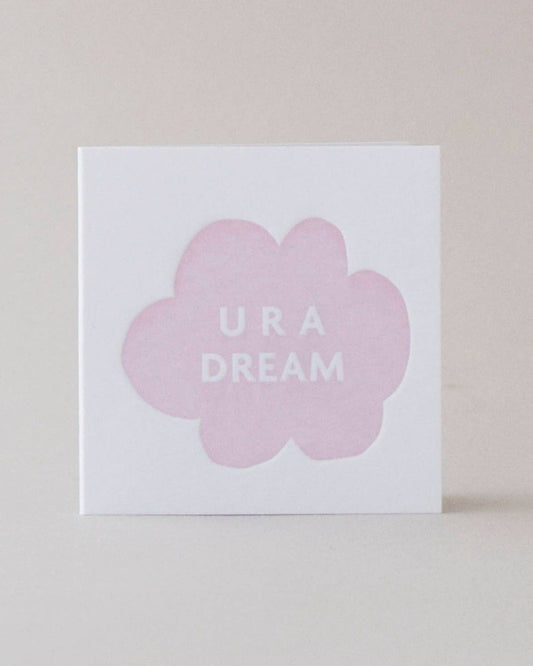 A mini square greeting card with 'U R A Dream' printed in a pink design and an envelope.