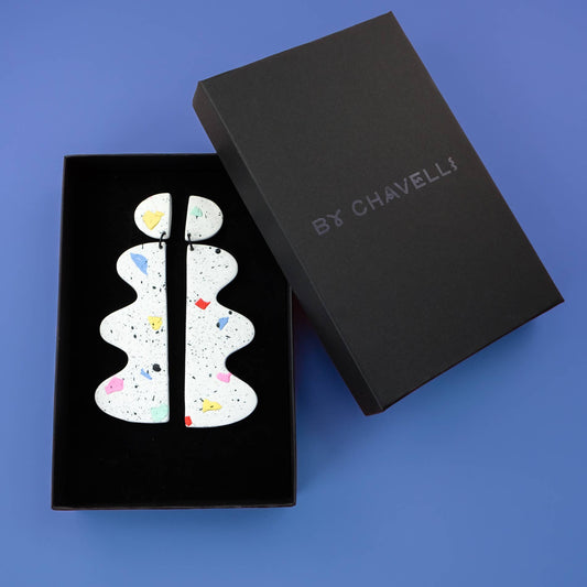 Black box with 'By Chavell' branding containing a white decorative item on a blue background