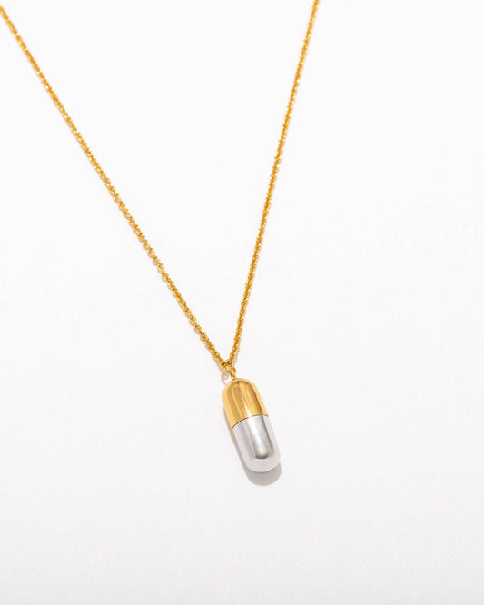 gold plated necklace with a pill pendant