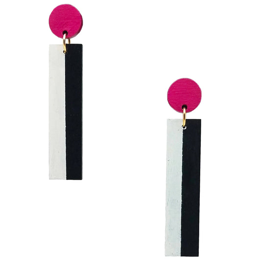 A pair of geometric dangle earrings featuring a bright pink circular stud connected to a vertical rectangular bar split down the middle into white and black sections, shown on a plain white background.