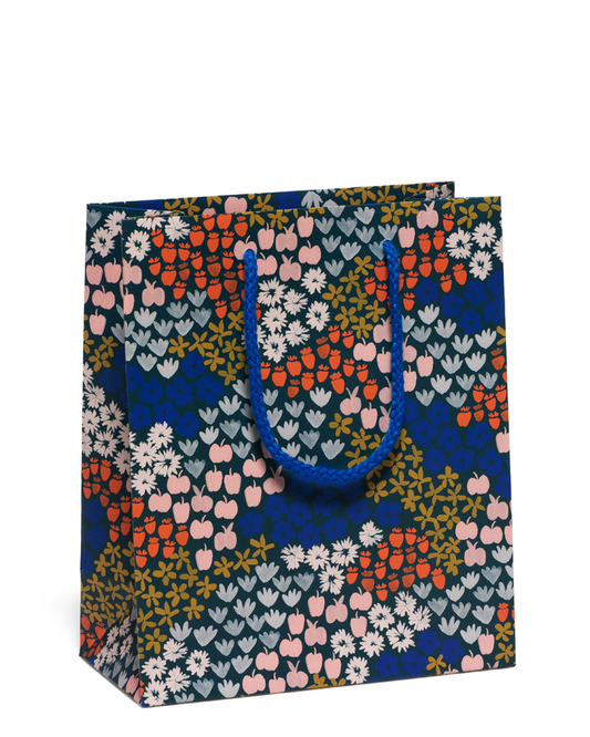 Floral patterned gift bag on a white background
