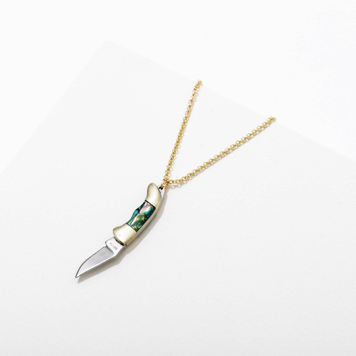 tiny functional pocket knife pendant on a gold chain