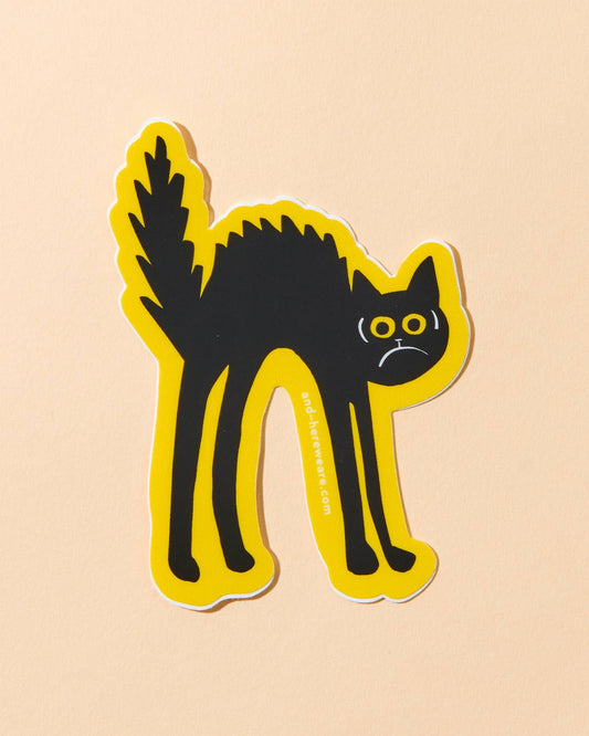vinyl sticker of a black cat looking scared