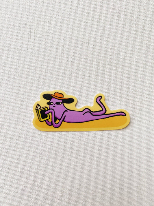 Cartoon sticker of a purple person lounging with a hat and sunglasses on a yellow background