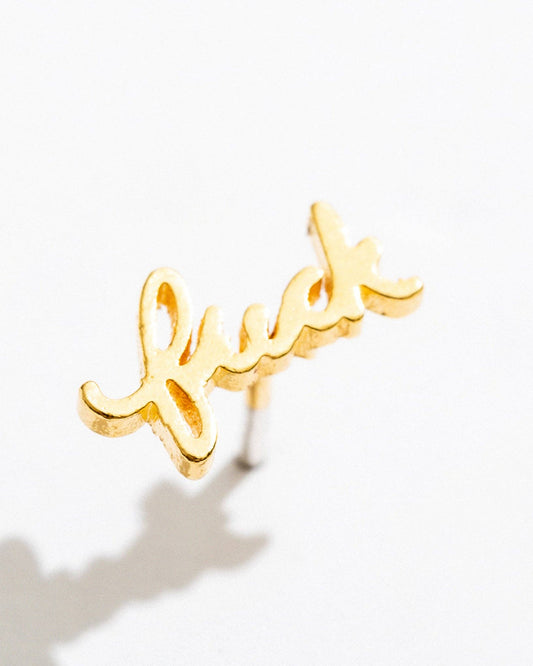 gold f*ck earring on a white background