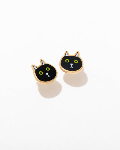 A pair of black cat-themed enamel stud earrings with gold-colored accents, displayed against a white background.