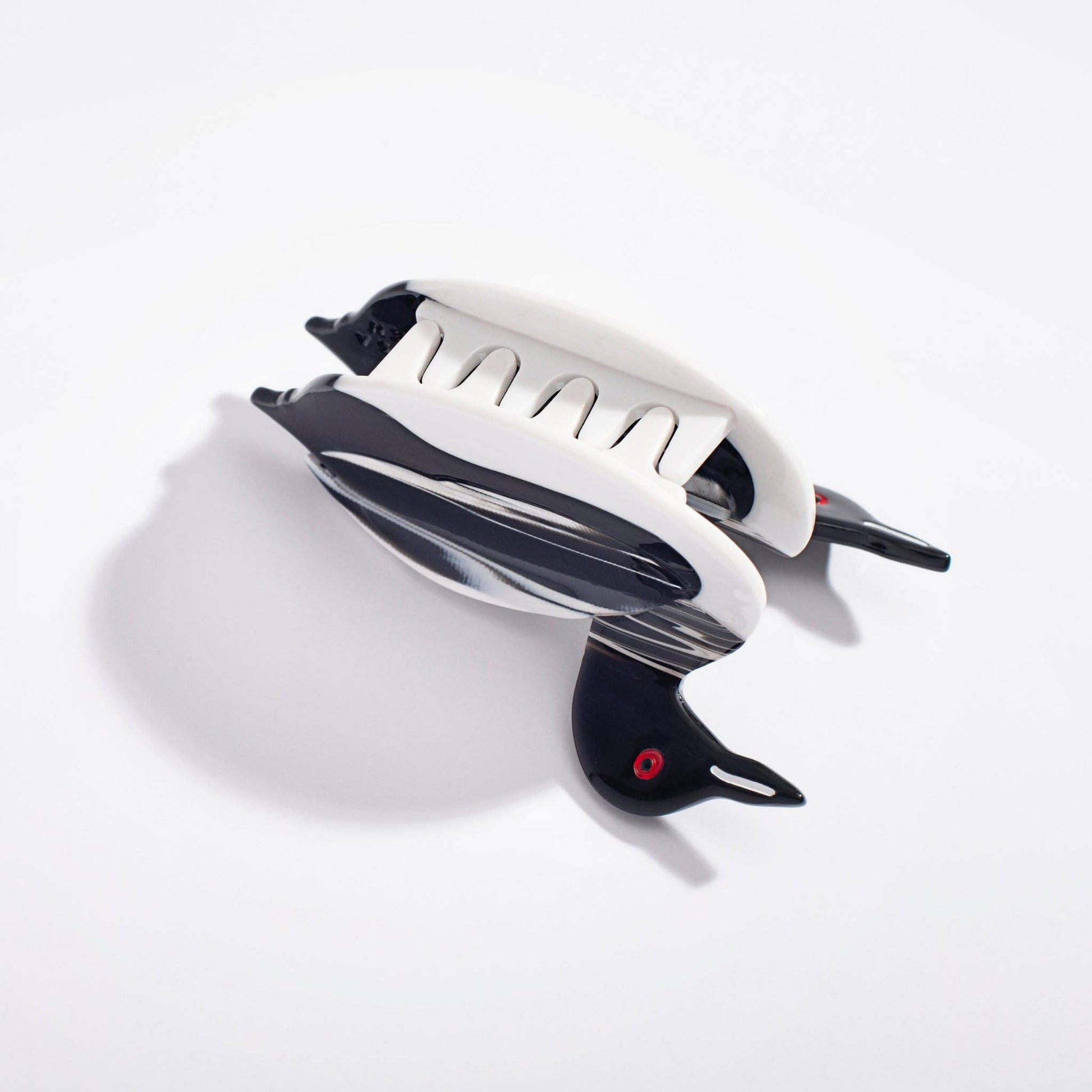 Black and white loon-shaped hair dryer on a white background