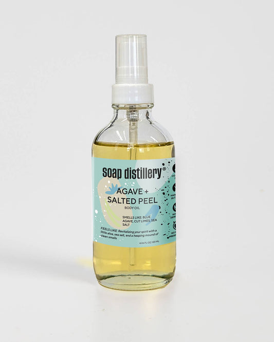 Bottle of Soap Distillery Agave + Salted Peel body oil in a glass container on a white background