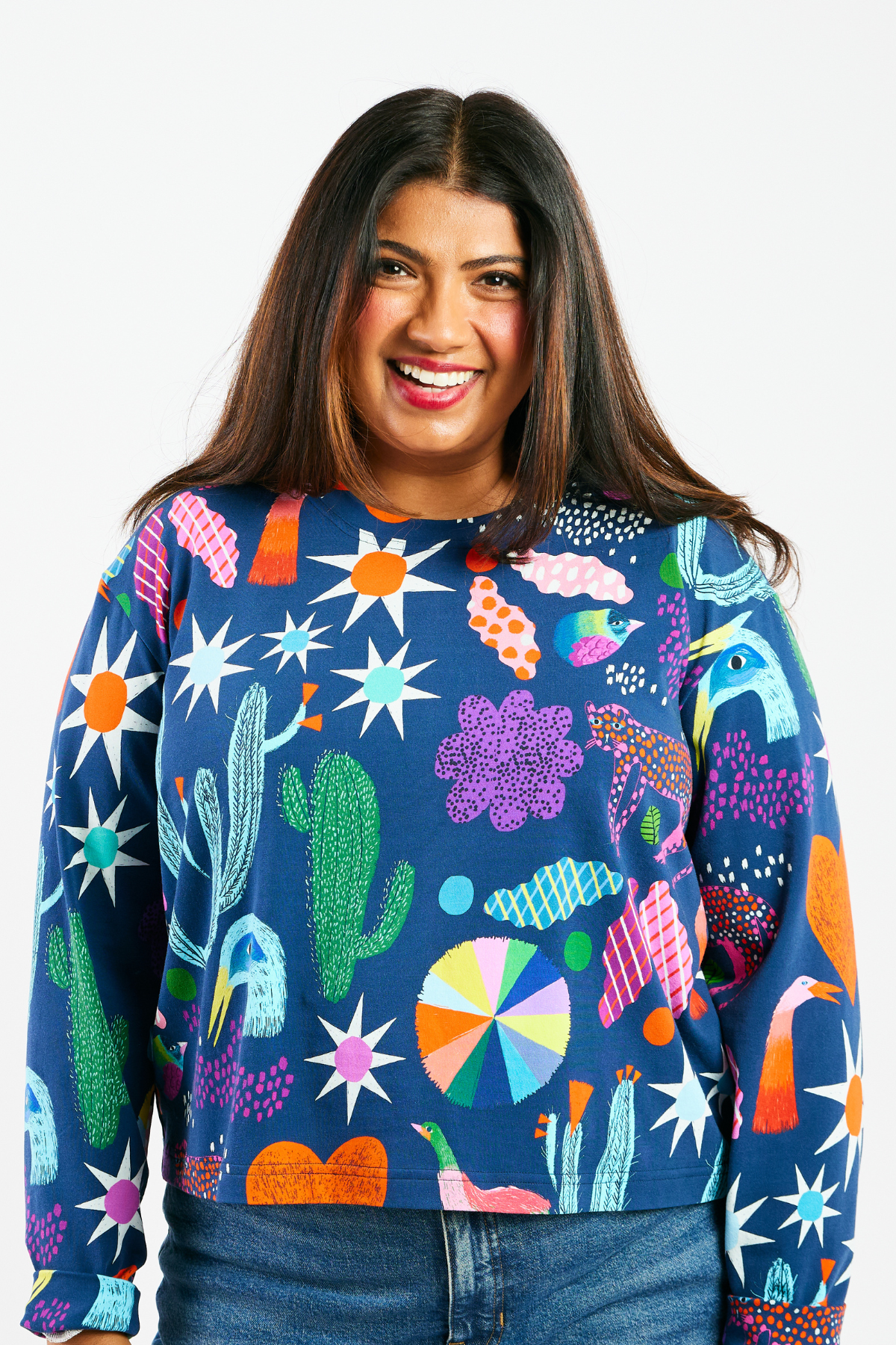 Woman wearing a colorful patterned shirt with abstract shapes on a white background