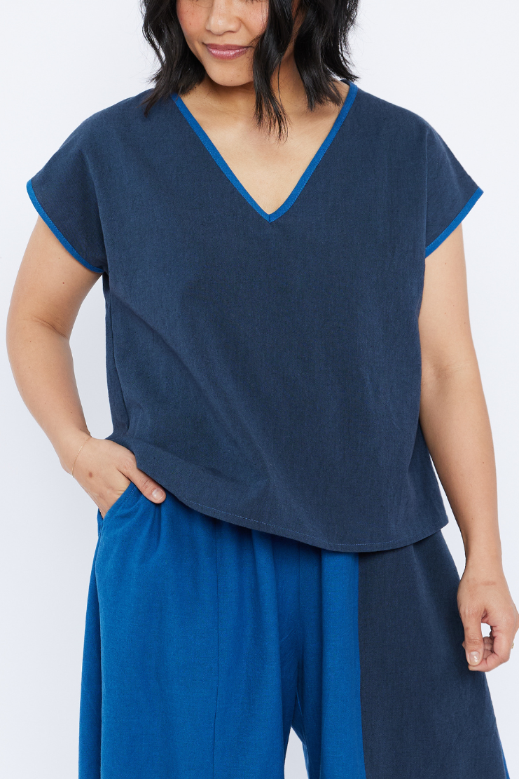 Woman wearing a blue outfit with a plain background