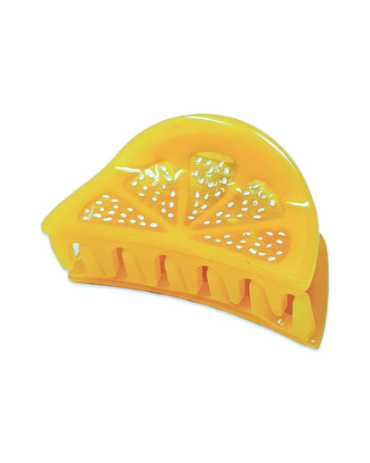 A yellow hair claw clip designed to resemble a mini lemon slice, with white dots on the clip body for a patterned design.