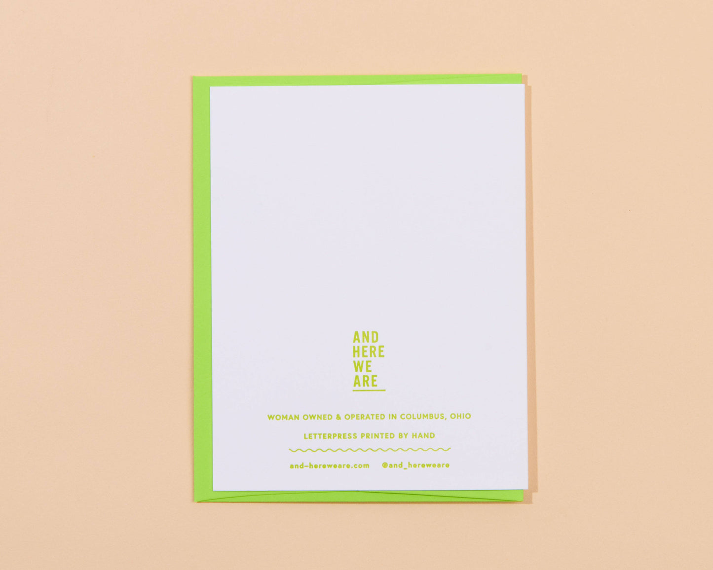 White card with green border and yellow text on a beige background