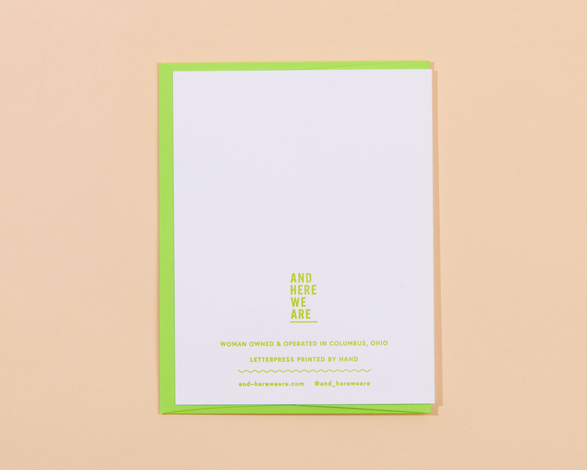 White card with green border and yellow text on a beige background