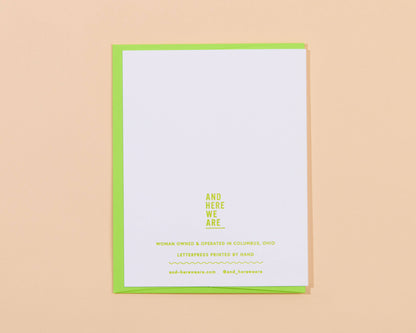 White card with green border and yellow text on a beige background