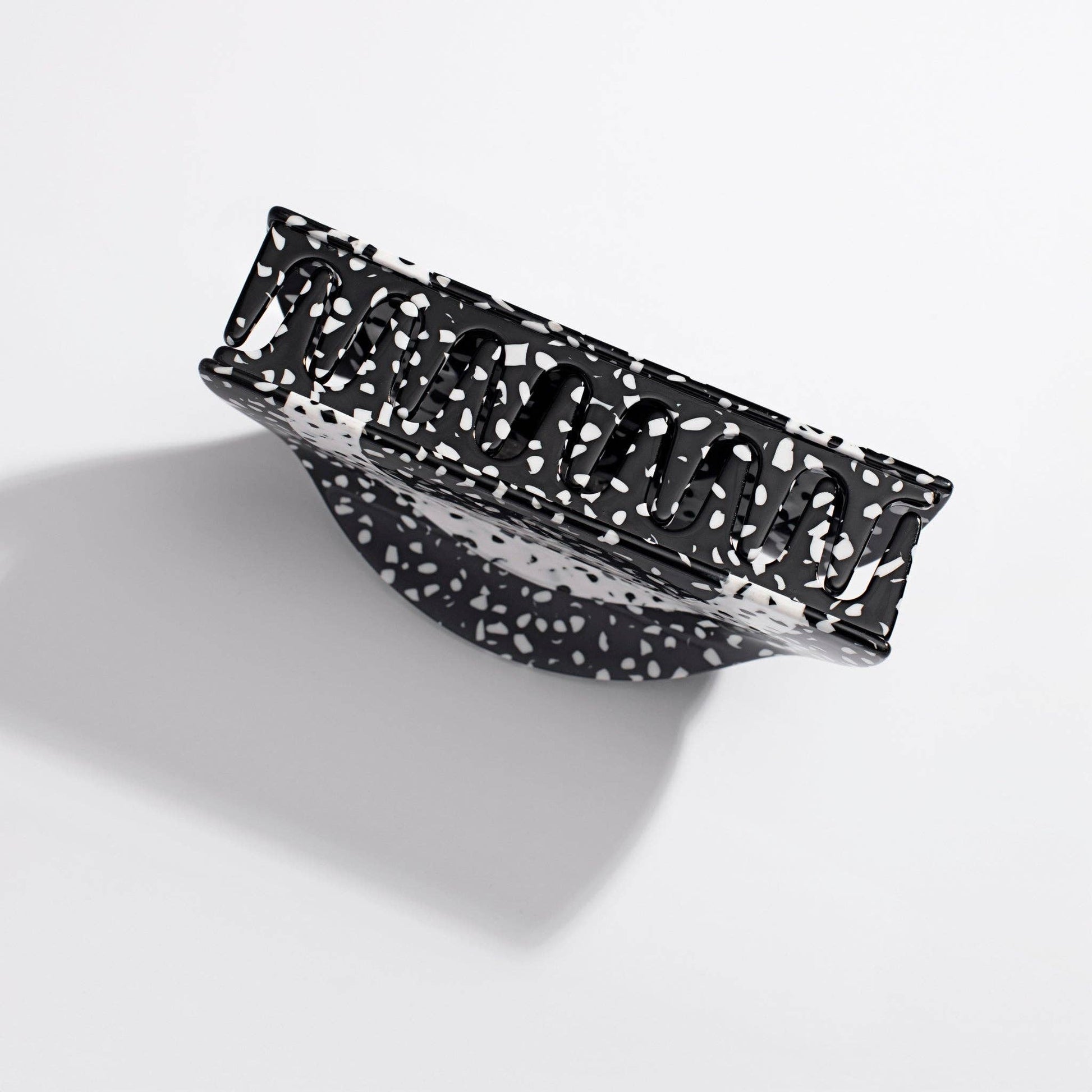 Black and white patterned rectangular object on a light gray background