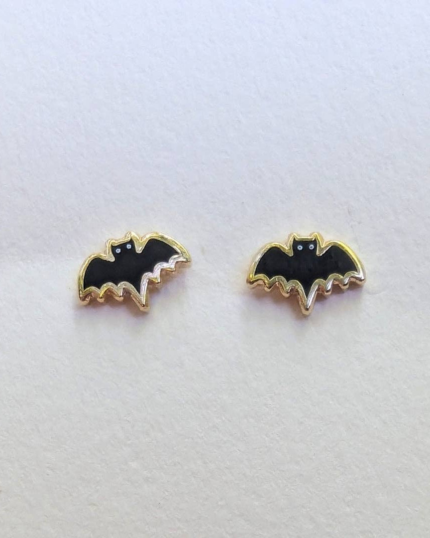 Bat-shaped stud earrings on a white background