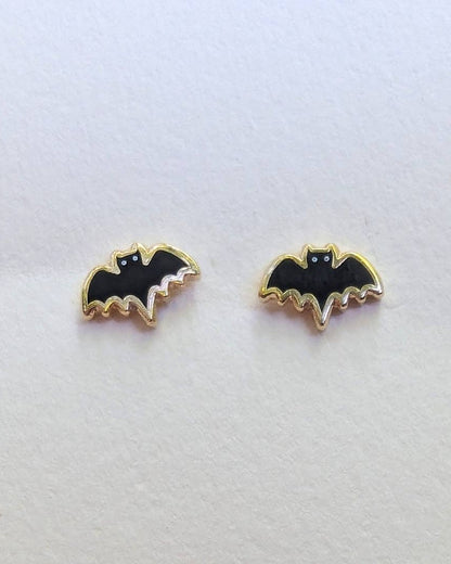 Bat-shaped stud earrings on a white background