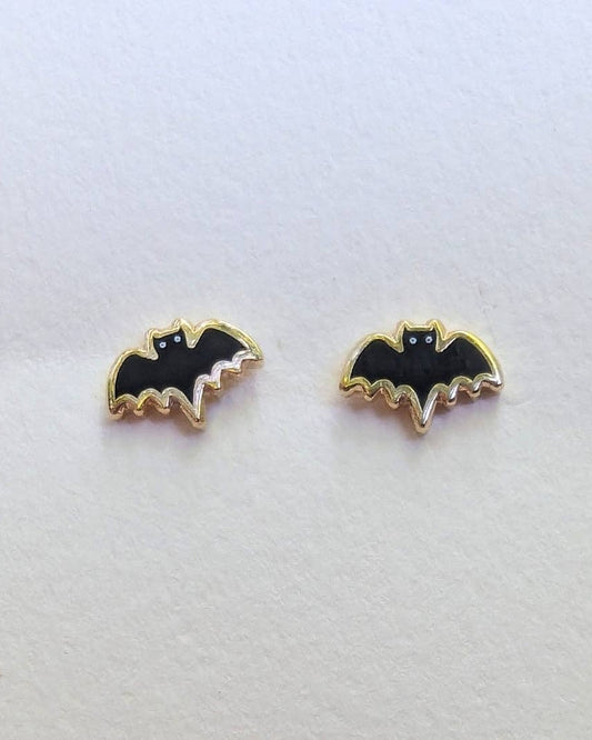 Bat-shaped stud earrings on a white background