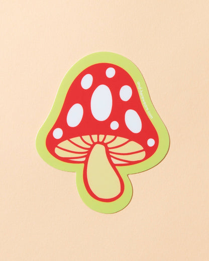 Sticker of a red mushroom with a green border on a beige background