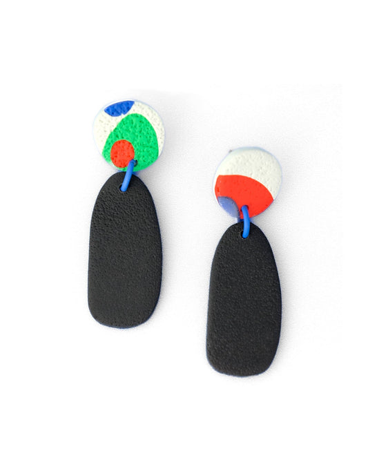 Pair of earrings with black oval shapes and colorful top sections on a white background
