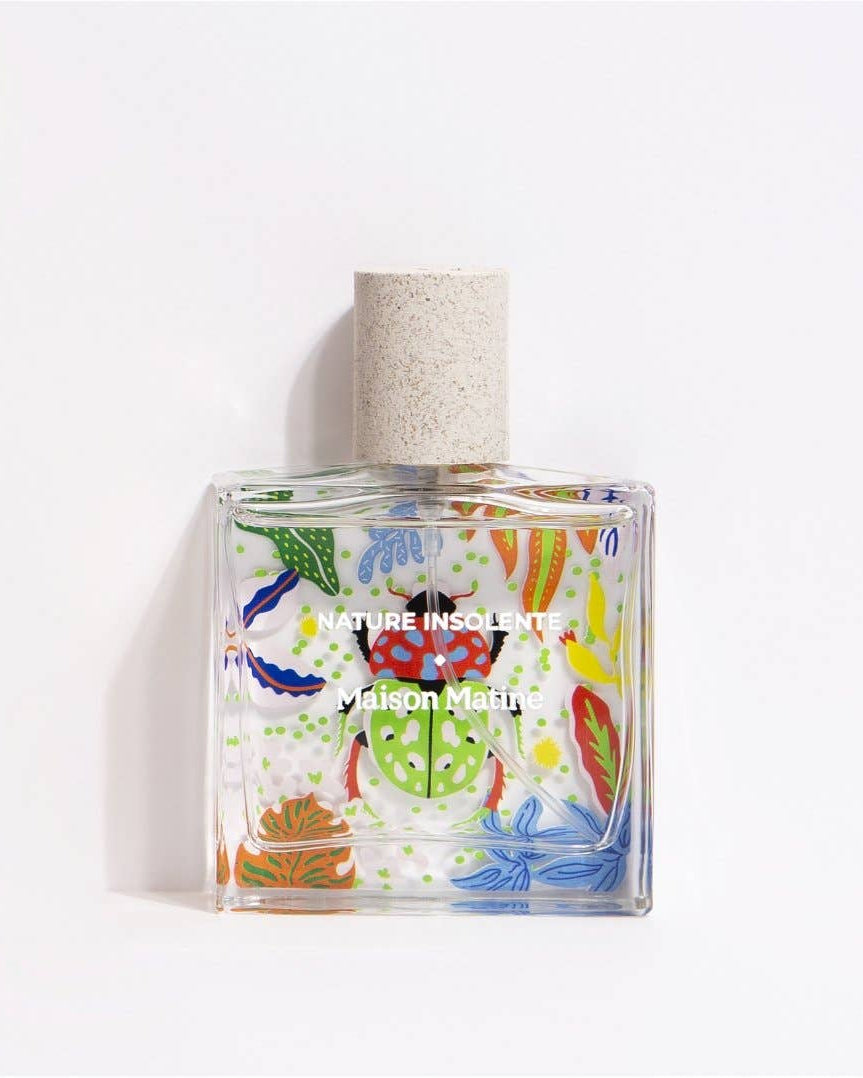 Glass bottle of eau de parfum with colorful art called Nature Insolente.