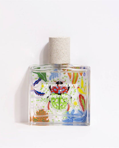 Glass bottle of eau de parfum with colorful art called Nature Insolente.