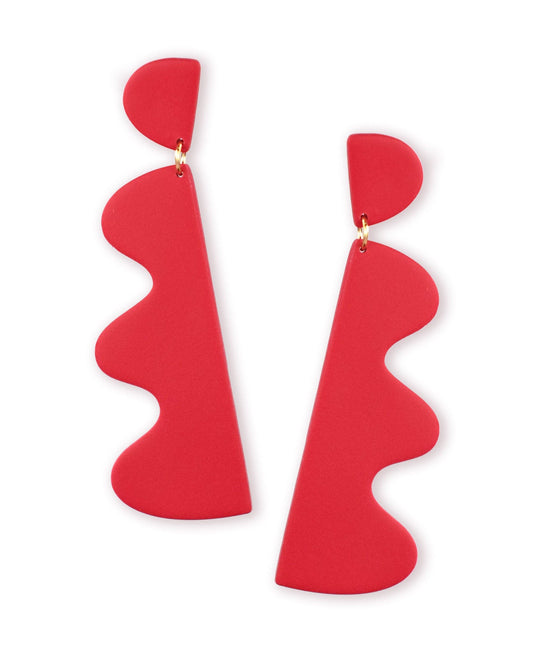 Red statement earrings on a white background