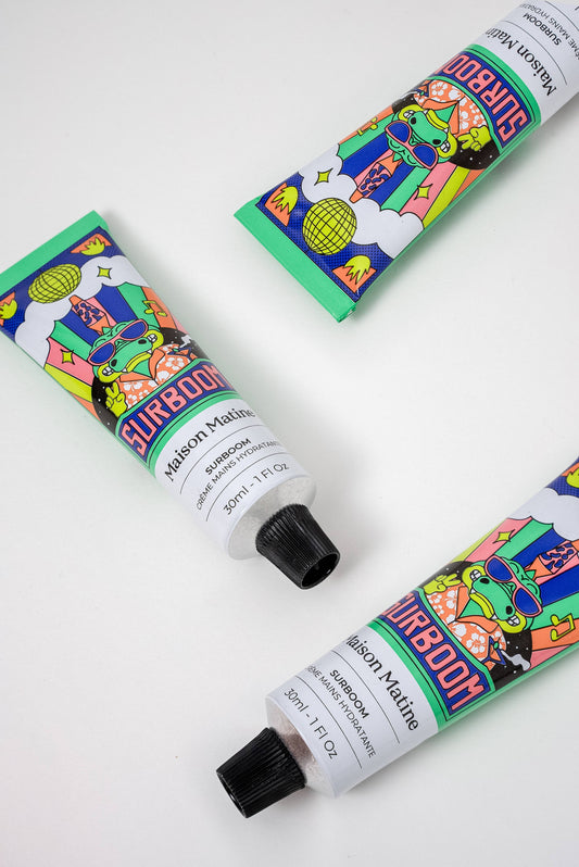 Three tubes of Surboom floral hand cream on a white background