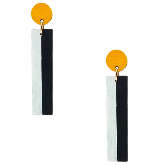 A pair of geometric dangle earrings featuring a vertical rectangular bar split into white and black halves, suspended from a round yellow top disc with a small gold ring connector, shown against a plain white background.