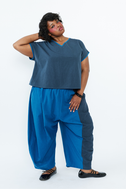 Woman wearing a blue outfit with a plain white background