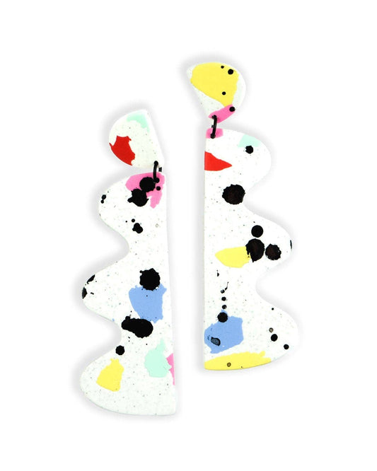 Pair of colorful statement earrings with abstract design on a white background