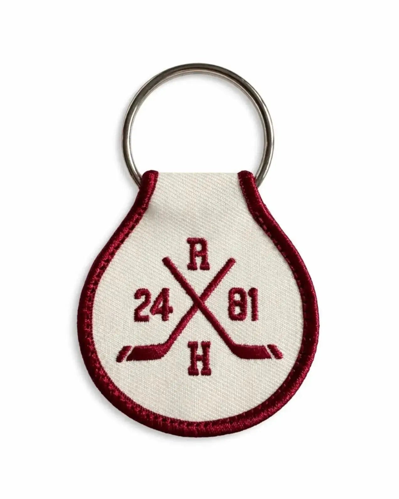 Keychain with Heated Rivalry embroidered design on a white background