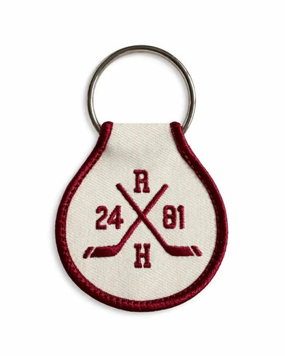 Keychain with Heated Rivalry embroidered design on a white background