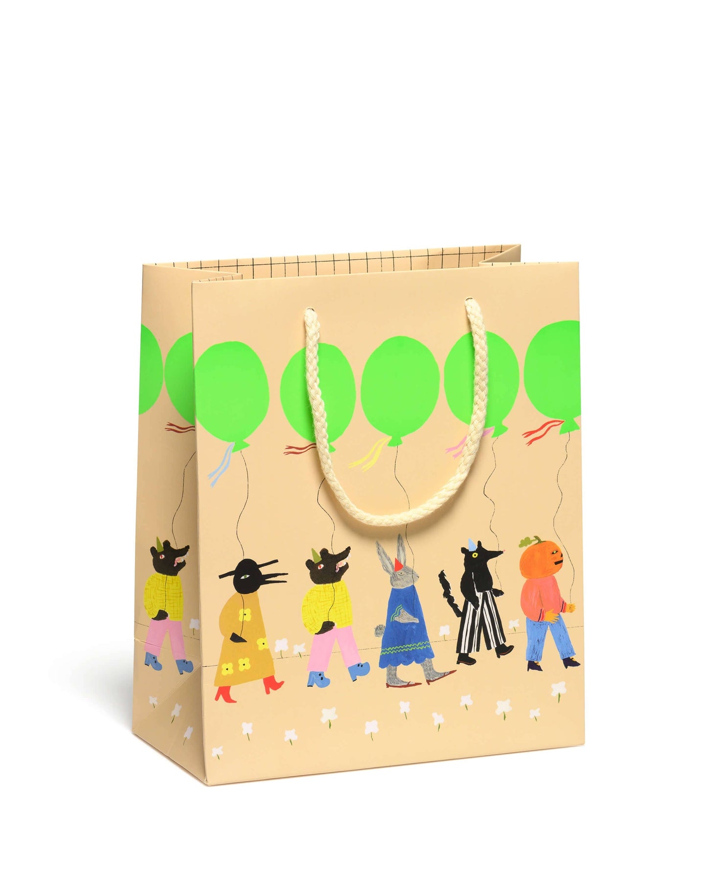 Gift bag with cartoon characters and green balloons on a beige background