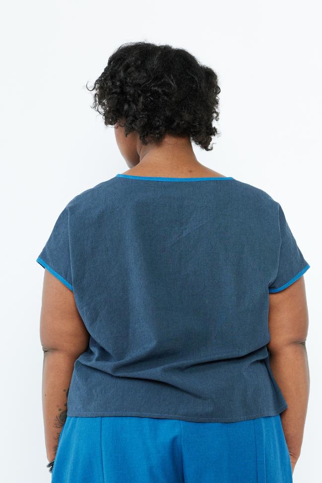Person wearing a blue outfit with a plain background