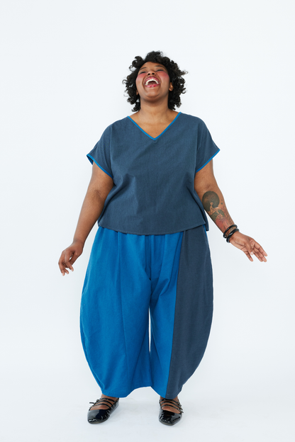 Person wearing a blue outfit with a white background