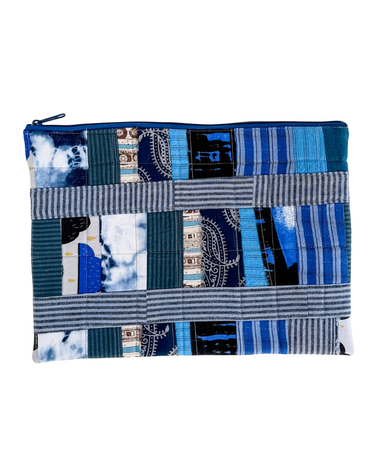Patchwork pouch with blue and gray pattern on a white background