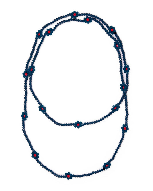 A long beaded necklace with dark blue beads and small red flower-shaped accents, displayed on a plain white background.