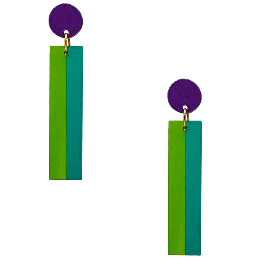 A pair of geometric drop earrings featuring a circular purple stud connected to a vertical rectangular bar with two colored panels: one bright green and one teal. The bars are suspended from gold-tone rings on a plain white background.